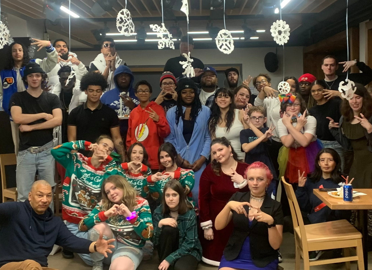 Group of people posing together in a room with festive decorations